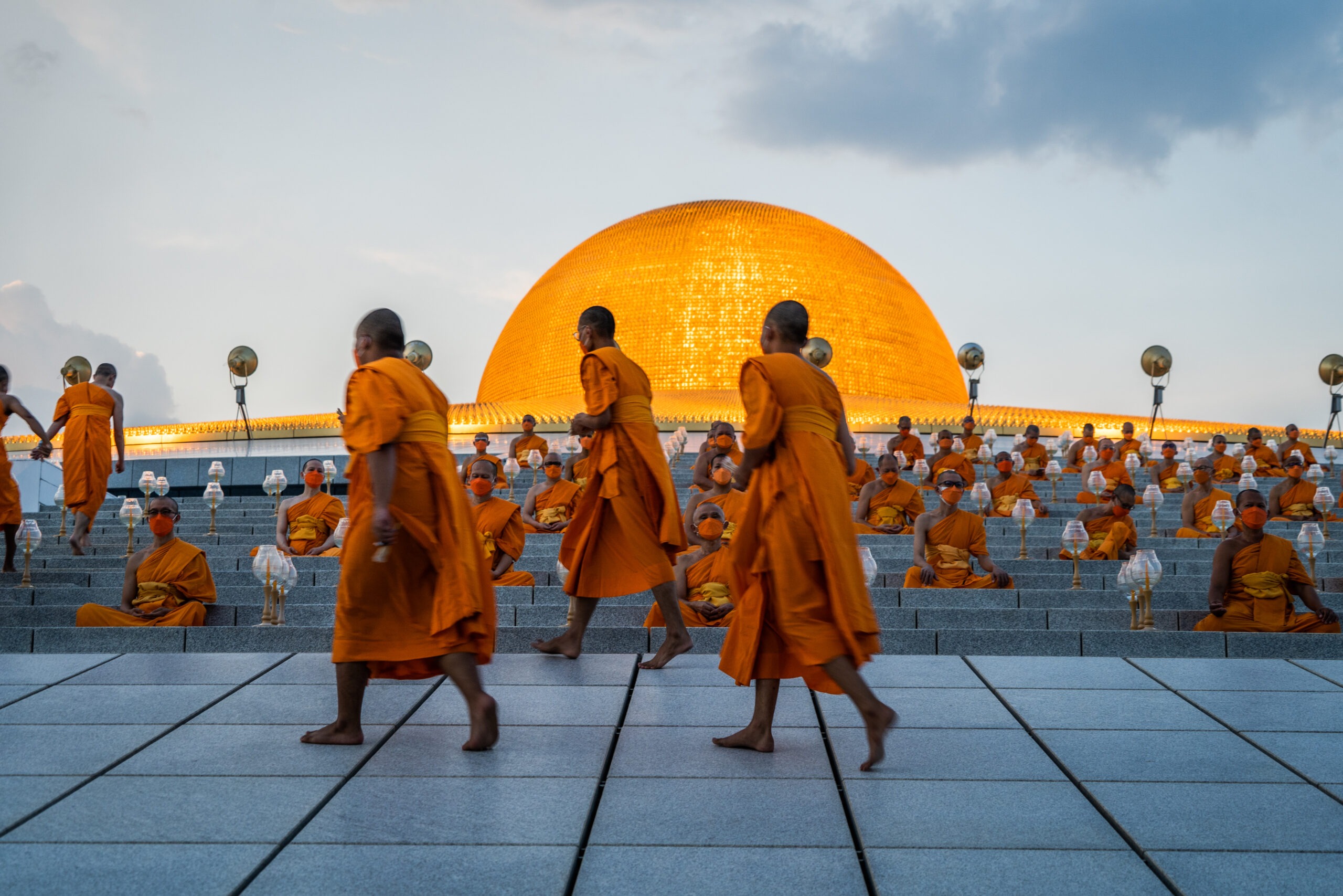 Candlelight procession illuminating Wat Phra Dhammakaya during a festival. 